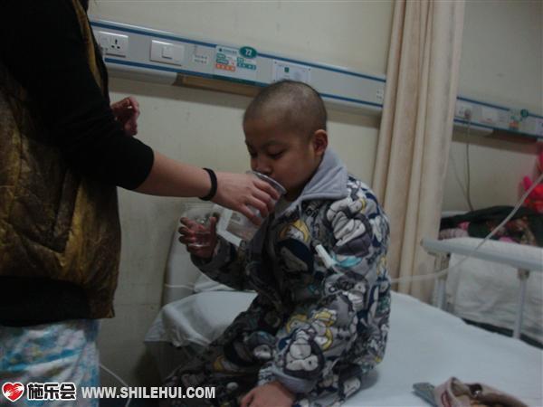 妈妈在给小启轩喂药。