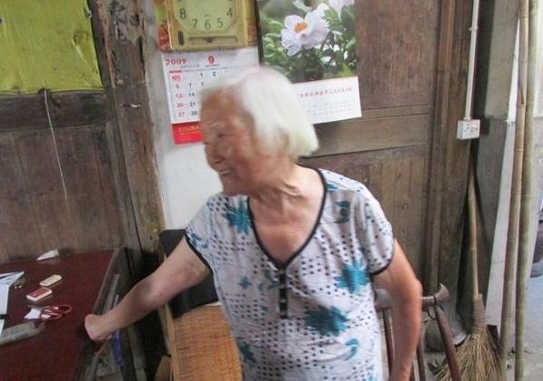 受助人陈菊兰在和志愿者讲诉家里的贫困情况